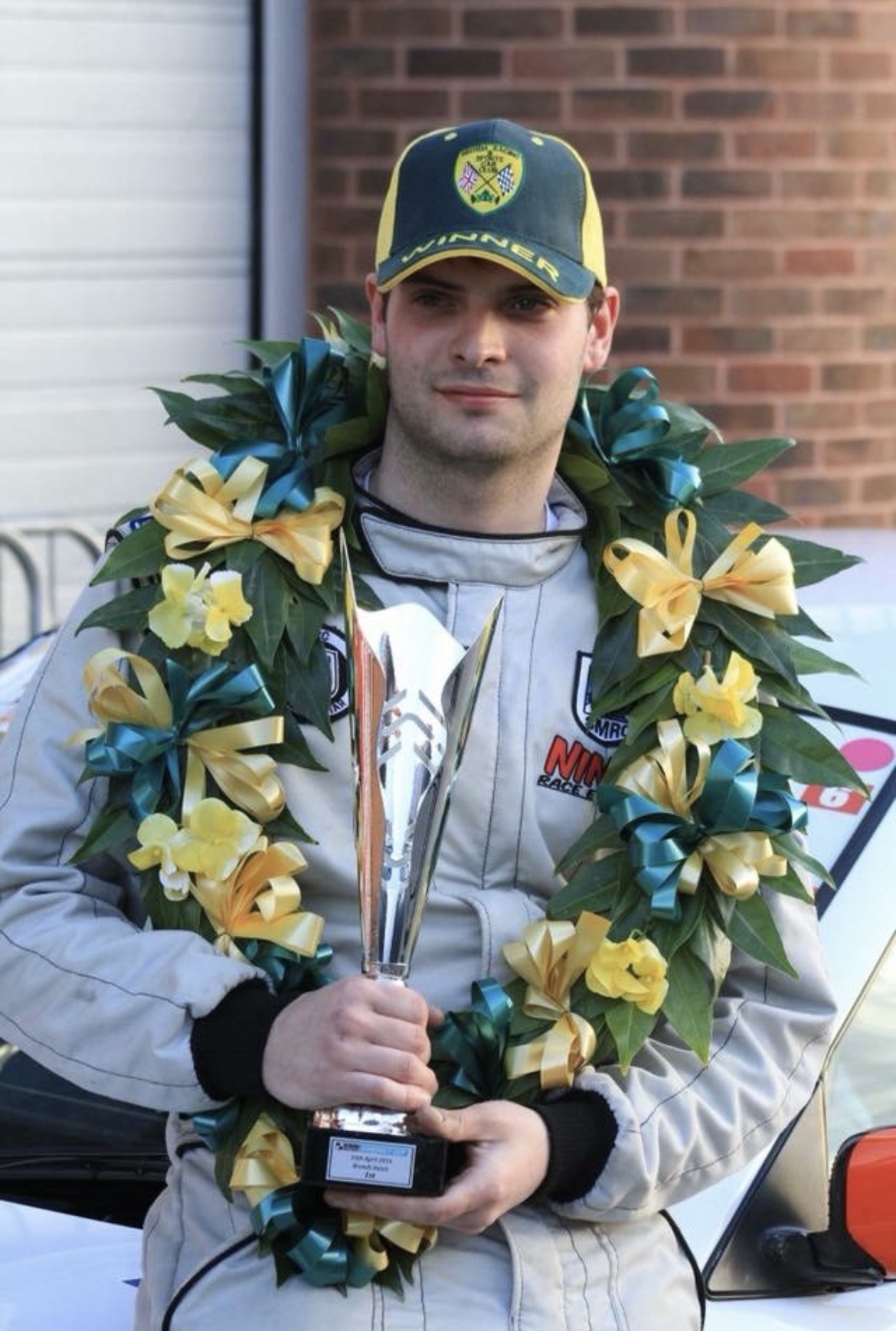 Steven with a winners wreath and trophy